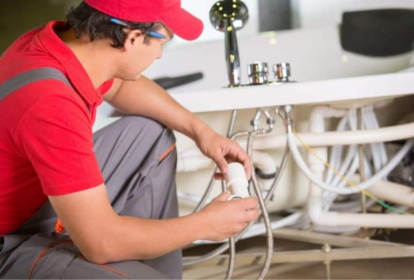 Professional plumbing services in Parma Heights installing pvc pipes in a home